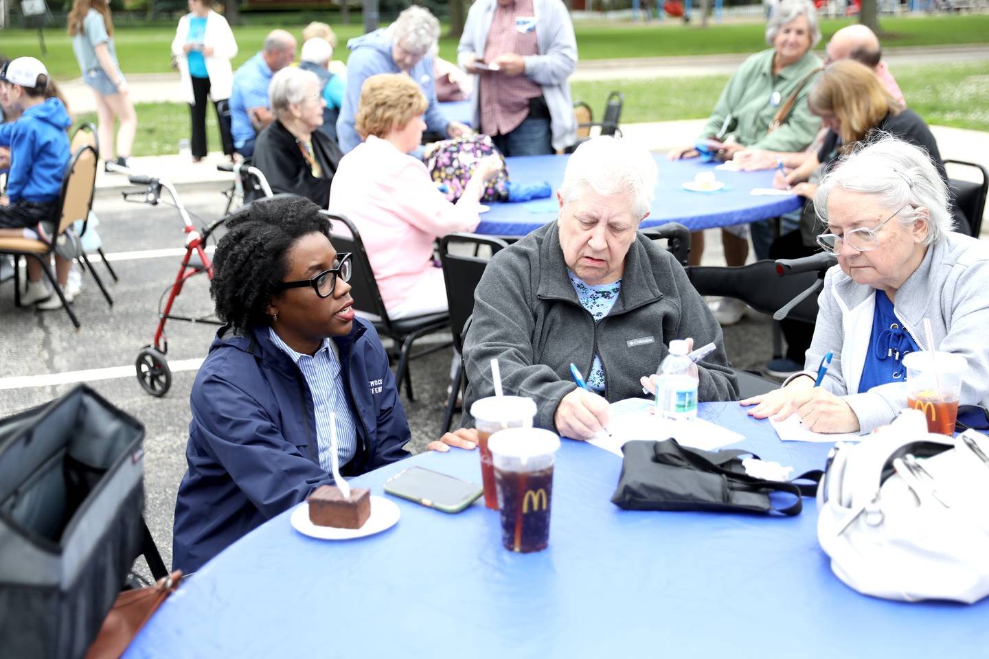 U.S. Rep. Lauren Underwood (D-Naperville) speaks to community members including Sharon Scholtes (center) and Mary Lou Martin, both of Oswego, against cuts to the federal Older Americans Act at the Senior Services Associates community center in Yorkville.