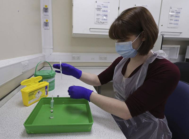 A NHS pharmacy technician at the Royal Free Hospital, simulates the preparation of the Pfizer vaccine to support staff training ahead of the rollout, in London, Friday Dec. 4, 2020.