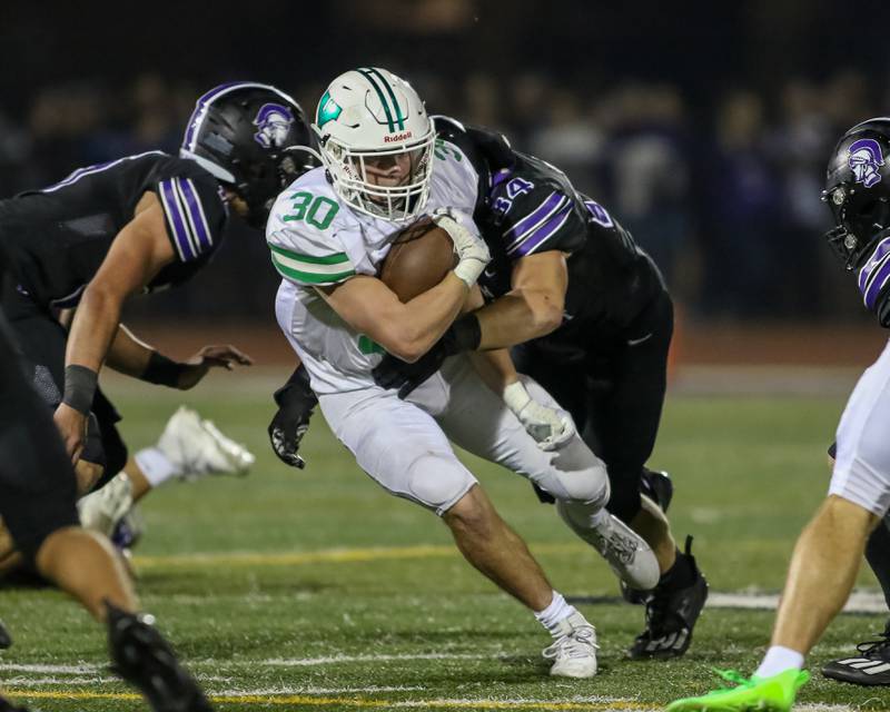 Downers Grove North's Jake Gregorio (34) brings down York's Jake Mellon (30) during football game between York at Downers Grove North.  Sept 29, 2023.