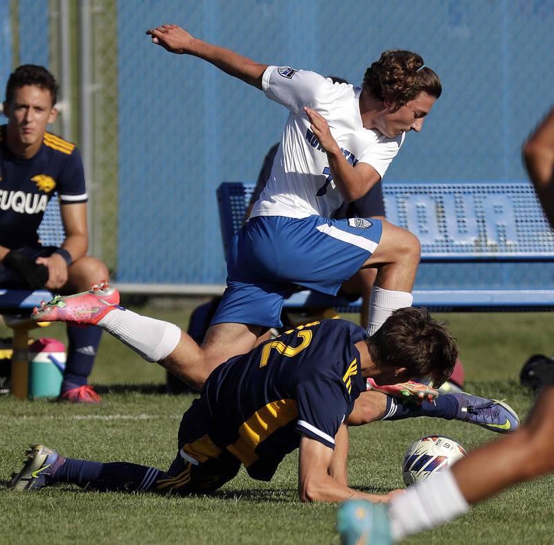 St Charles North's Arnel Dizdarevic (7) leaps over Neuqua Valley's Wesley Karubas (12) Thursday September 8, 2022 in Naperville.