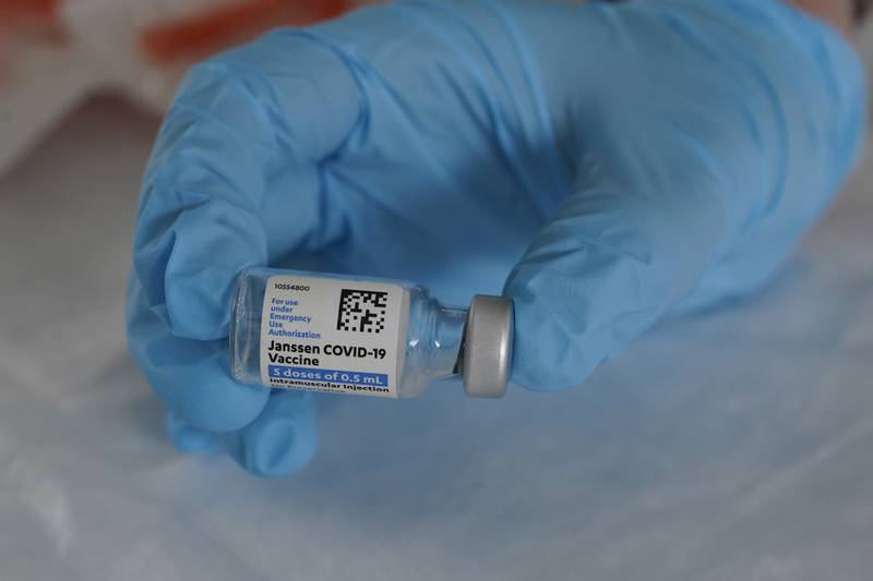 FILE - In this March 3, 2021, file photo, U.S. Army medic Kristen Rogers, of Waxhaw, N.C., holds a vial of the Johnson & Johnson COVID-19 vaccine in North Miami, Fla. With the U.S. pause of the vaccine, authorities are weighing whether to resume the shots the way European regulators decided to -- with warnings of a “very rare” risk. New guidance is expected late Friday, April 23, after a government advisory panel deliberates a link between the shot and a handful of vaccine recipients who developed highly unusual blood clots. (AP Photo/Marta Lavandier, File)