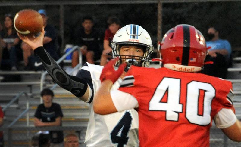 Plainfield South quarterback Connor Folliard (4) gets a pass off with pressure from blitzing Yorkville defensive back Blake Kersting (40) during a varsity football game at Yorkville High School on Friday.