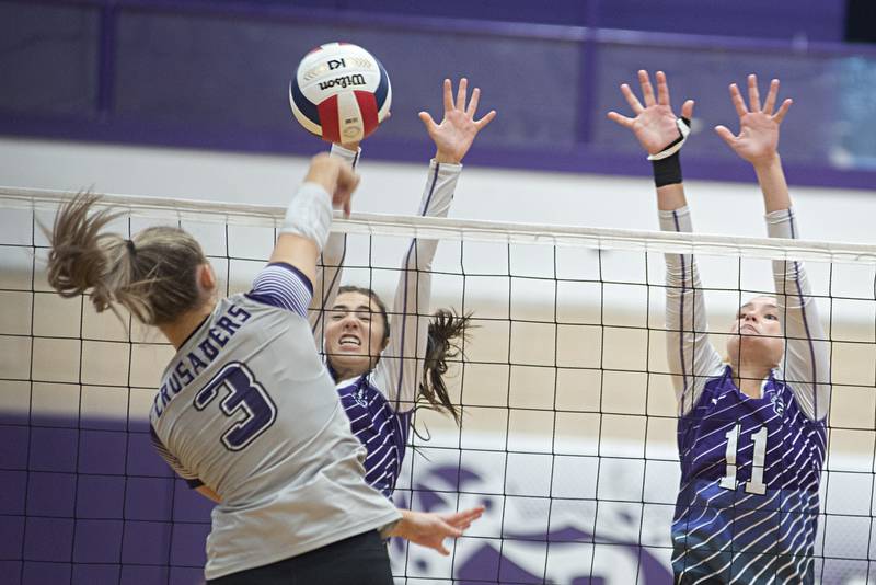 Dixon’s Sydney Hargrave (left) and Dixon’s Ella Govig go up to block a shot by Rockford Lutheran’s Aubree Pohl Tuesday, Sept. 20, 2022.
