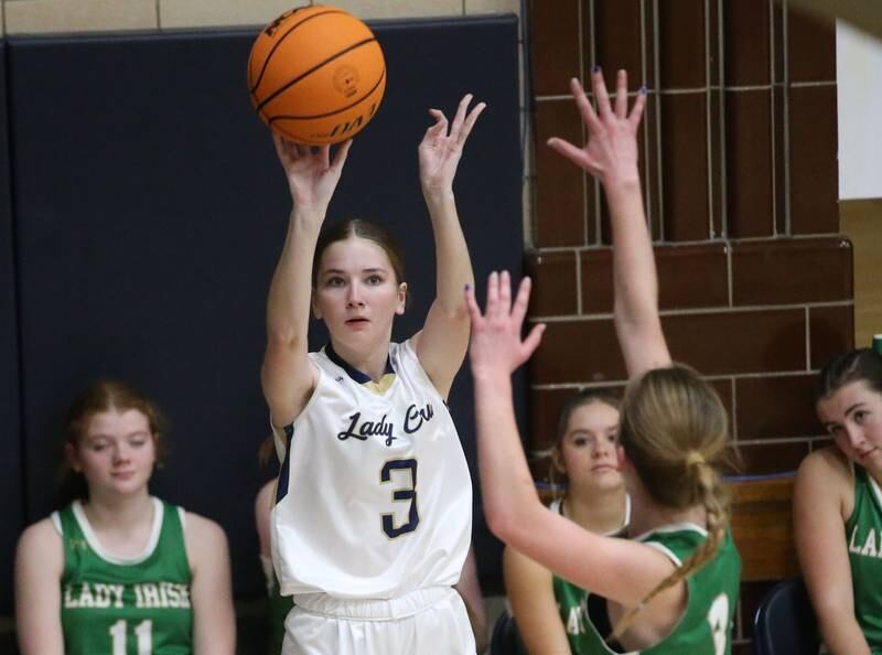 Marquette's Morgan Nelson sinks a three-point basket over Seneca's Evelyn O'Connor on Thursday, Dec. 5, 2024 in Bader Gym at Marquette High School.