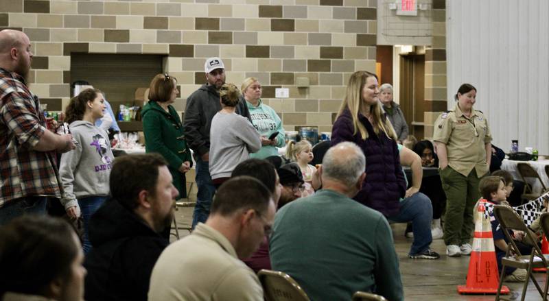 Parents gather around the finish line area to see their children race during the Cub Scout Pack 85 Pinewood Derby on Saturday, Feb. 11, 2023 at Bethel Evangelical Congregational Church in Dixon.