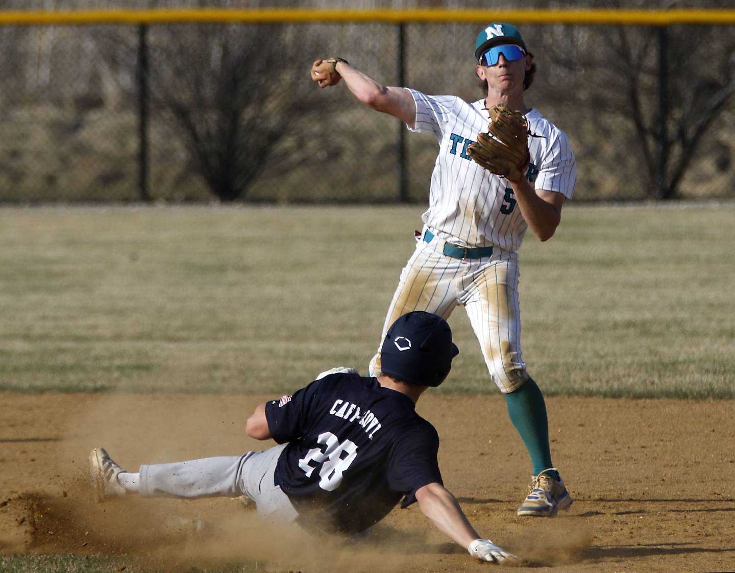 Woodstock North's Tristan Schaffter waits for the throw as Cary-Grove's Kaden Norman slides into second base during a nonconference baseball game on Monday, March 30, 2026, at Woodstock North High School.