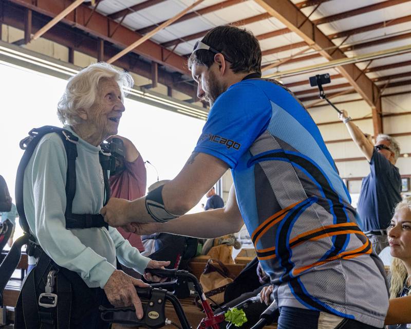 Skydive Chicago staff tighten the tandem harness in preparation for Dorothy Hoffners record breaking attempt on October 1, 2023.