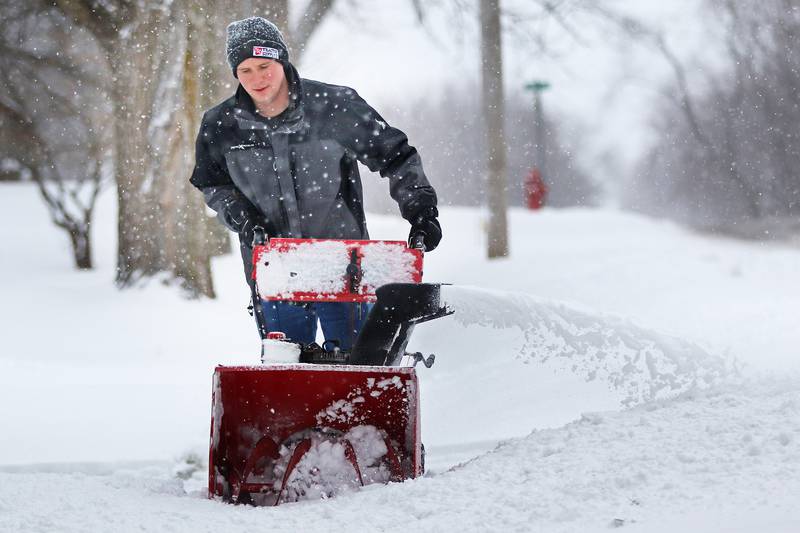 David Petrovich of Huntley uses a snowblower to clear his property on Tuesday, Jan. 26, 2021 in Huntley.
