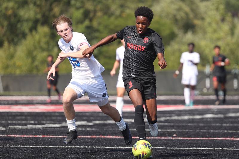 Lincoln-Way East’s Jack Dudzik shadows Bolingbrook’s Kamsi Ifeajekwu on Saturday, Sept. 30, 2023 in Bolingbrook.