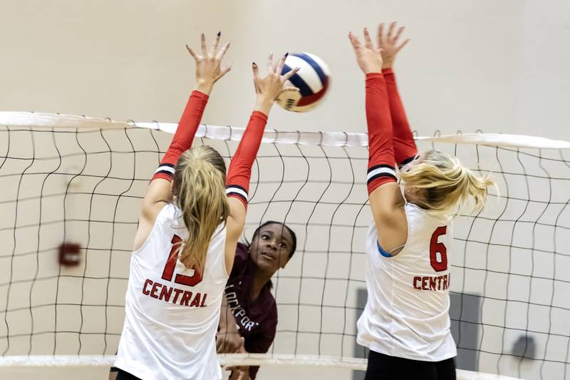 Lincoln-Way Central's Stella Davis and Kaitlyn Hedrich attempt to block a hit from Lockport's Malia Cole during a varsity volleyball game at Lincoln-Way Central on Oct. 9, 2025.