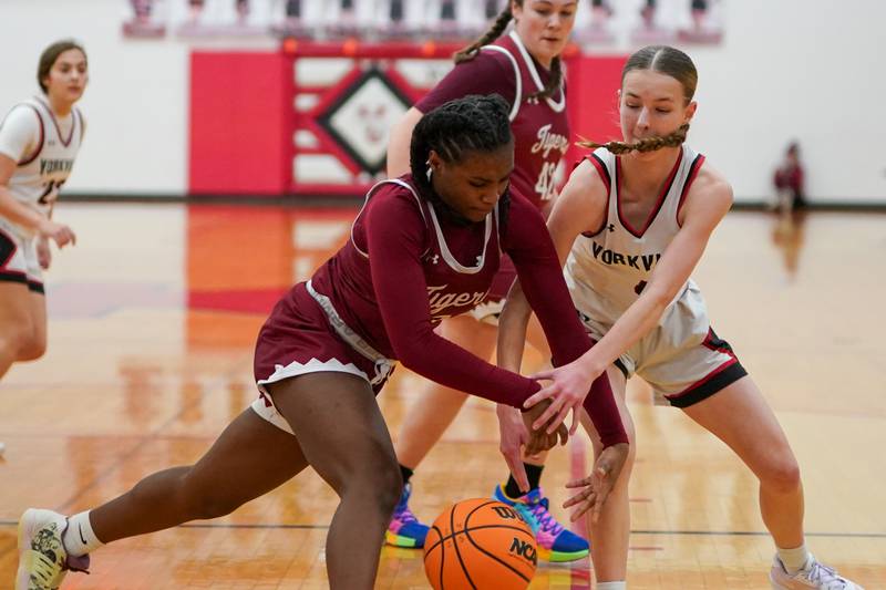 Plainfield North's Anaya Patterson (15) and Yorkville's Macie Jones (4) fight for a loose bal during a basketball game at Yorkville High School on Tuesday, January 10, 2017.