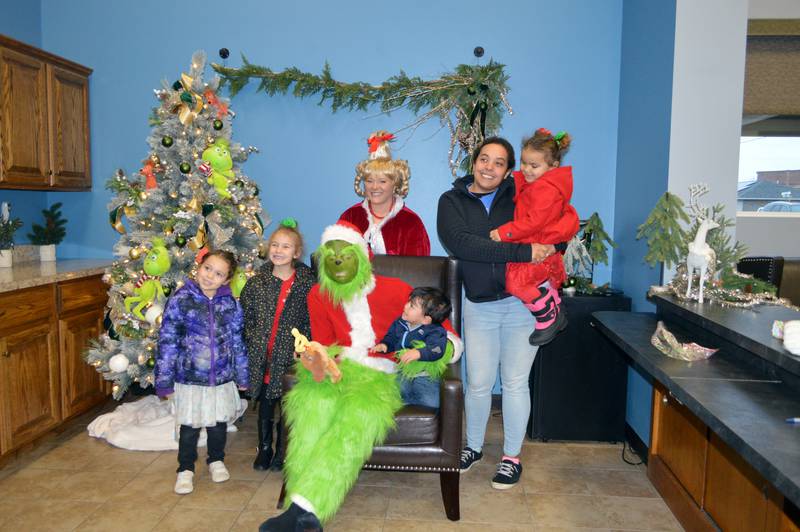 The Grinch and Cindy Lou pose for a photo with guests at Polo's Crossroads Community Church's Winter Carnival on Saturday, Dec. 2, 2023. Left to right are: Londyn Olivares, 5; Kynnedi Smith, 6; the Grinch and Cindy Lou; Renzo Olivares, 1; Courtney Thompson, of Polo; and Kambri Smith, 3. The Winter Carnival was part of the fifth annual Polo Christmas Festival.