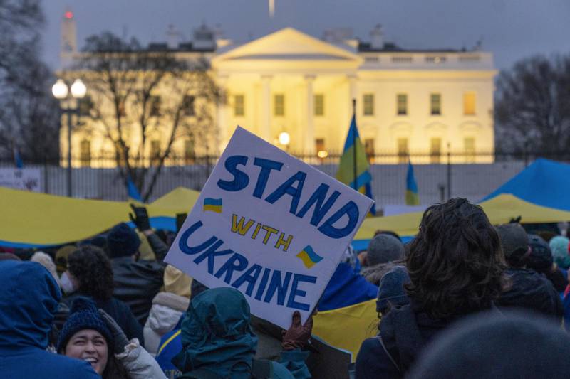 People take part in a vigil to protest the Russian invasion of Ukraine in front of the White House in Washington, Thursday, Feb. 24, 2022. (AP Photo/Andrew Harnik)