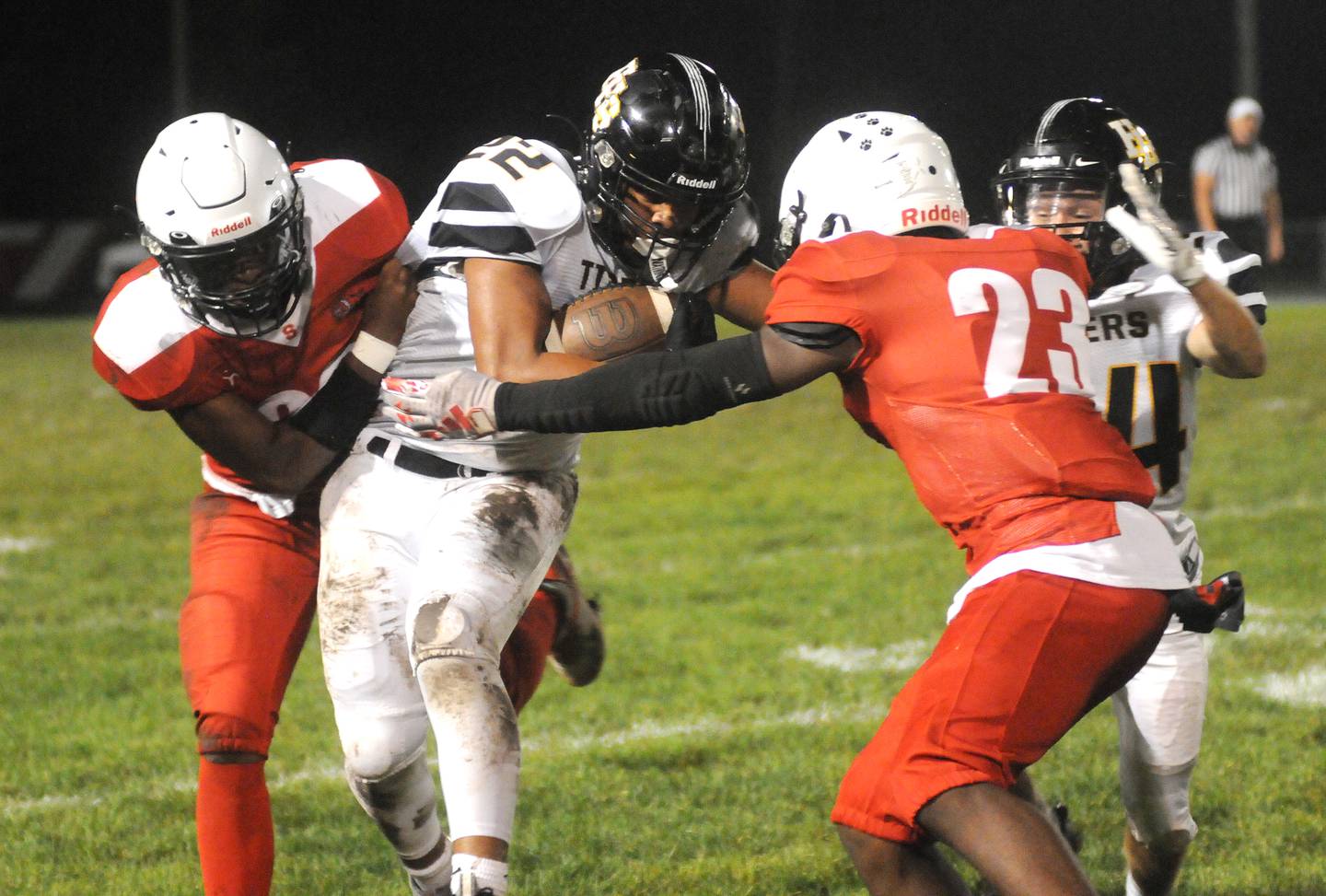 Streator's Tyrese Hendrix and Jordan Lukes (23) team up to take down Herscher's Alek Draper (22) as his teammate, Connor Massie-Devore, tries to assist at Doug Dieken Stadium on Friday, Sept. 22, 2023.