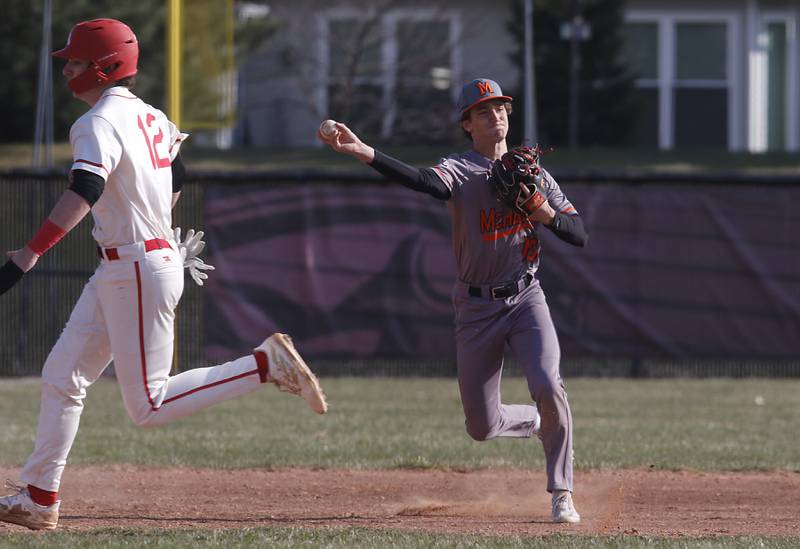 McHenry’s Jeffry Schwab throws to first base and Huntley's Anthony (AJ) Putty runs during a Fox Valley Conference baseball game on Friday, April 11, 2025, at Huntley High School.