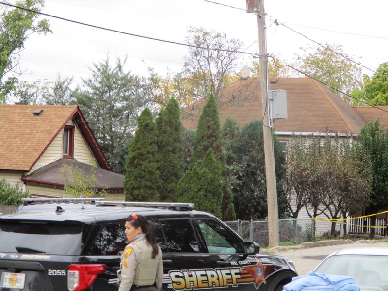 Will County Sheriff's police on Sunday, Oct. 31, 2021 blocked access to the section of east Jackson Street leading to the Joliet Township house, seen in the distance behind yellow police tape,  where two people were killed and at least a dozen more shoot at a Halloween party about at about 12:39 a.m.