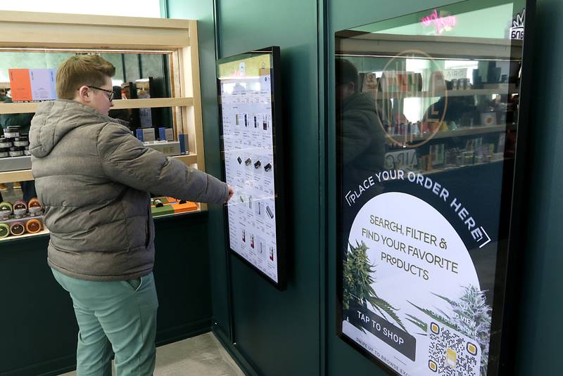 A person looks at the ordering system during an open house Thursday, Feb. 2, 2023, at the Ivy Hall Crystal Lake, a social equity-licensed cannabis dispensary that recently opened at 501 Pingree Road in Crystal Lake.