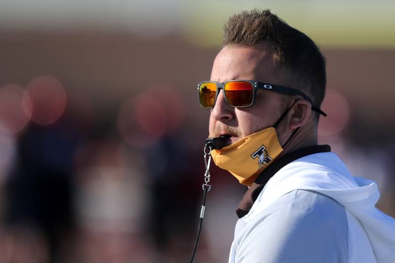 New Jacobs head football coach Brian Zimmerman watches his Golden Eagles warm up against Huntley during their season opening football game at Huntley High School on Friday, March 19, 2021 in Huntley.