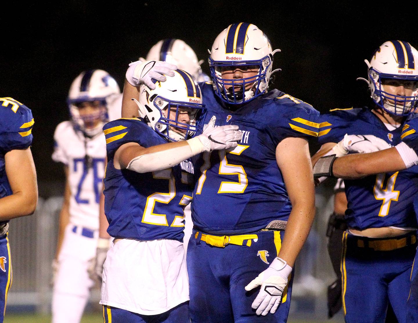 Wheaton North's Brayton Masks (23) and Gregory Fotinopoulos (75) celebrate Maske's touchdown during a home game against St. Charles North on Friday, Sept. 17, 2021.