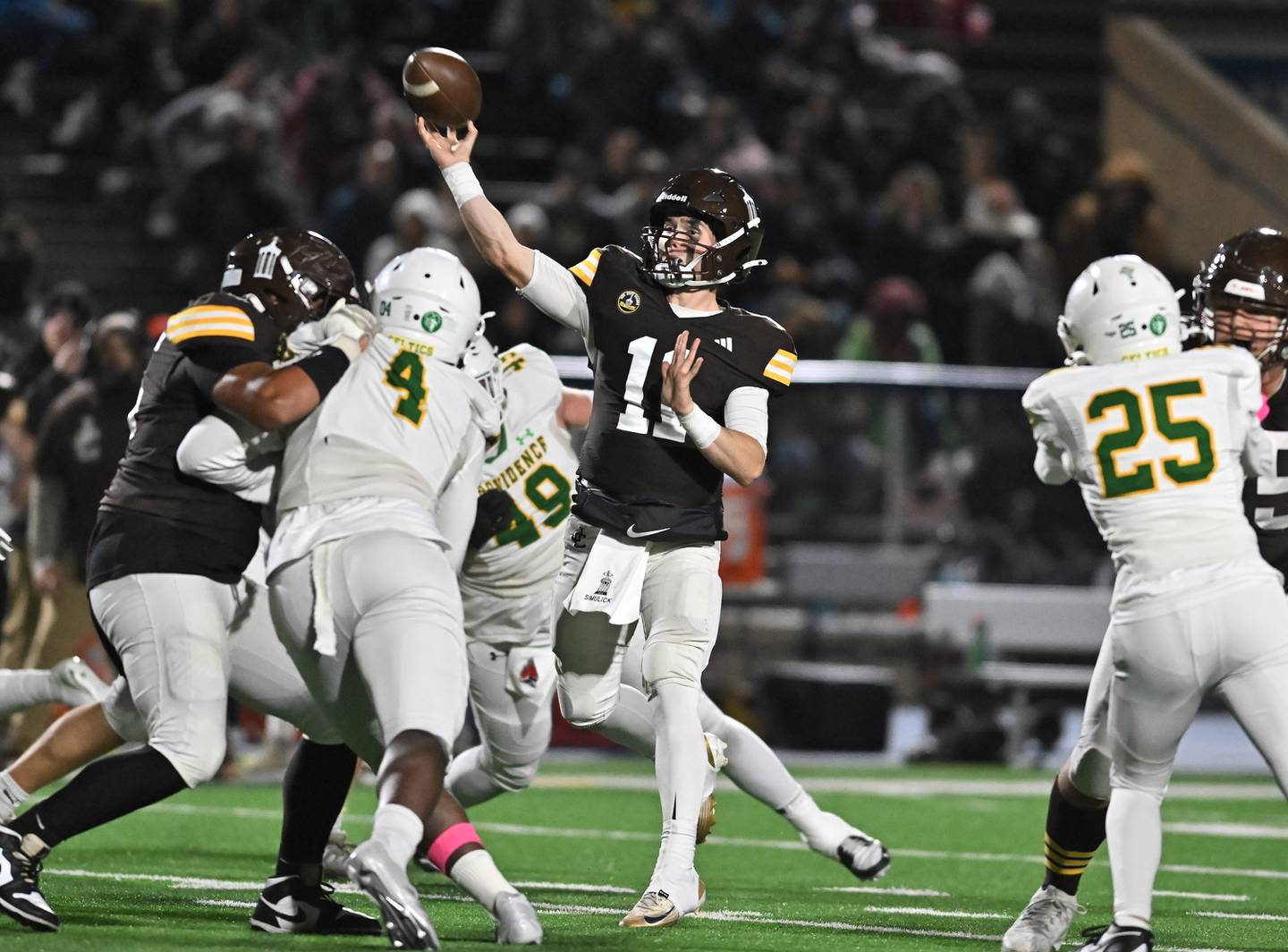 Joliet Catholic's Lucas Simulick (11) sits in the pocket to pass the ball during the conference game against Providence Catholic on Friday, OCT. 24, 2025, at Joliet.