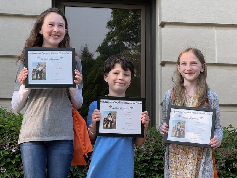 (L-R): 2023 Sycamore Pumpkin Festival theme contest runner up, Allison Vavra, a fifth grader from St. Mary's in Sycamore; contest winner Harrison Rowland of Southeast Elementary; and Finley McDonald, a fifth grader from Southeast Elementary School, pose with their certificates during a theme contest announcement for the festival Wednesday, May 17, 2023 outside the DeKalb County Courthouse, 133 W. State St., Sycamore.