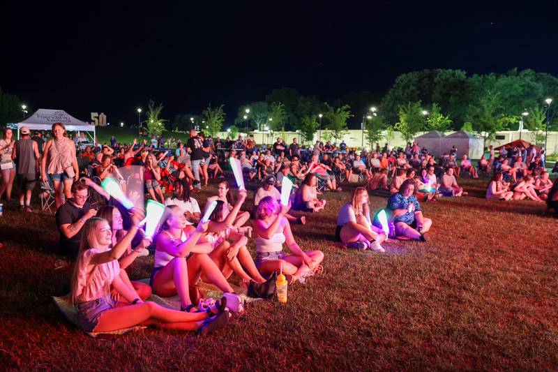 Attendees wave glow sticks as Fleetwood Gold performs during the 50th Bourbonnais Friendship Festival on Friday, June 27, 2025.