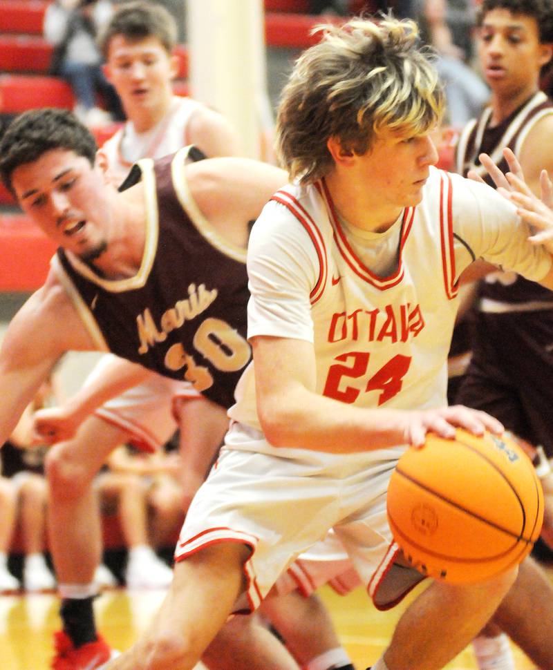 Ottawa junior George Shumway (24) looks for an open teammate as Morris senior Cade Laudeman defends on Friday, Dec. 12, 2025 at Kingman Gym.