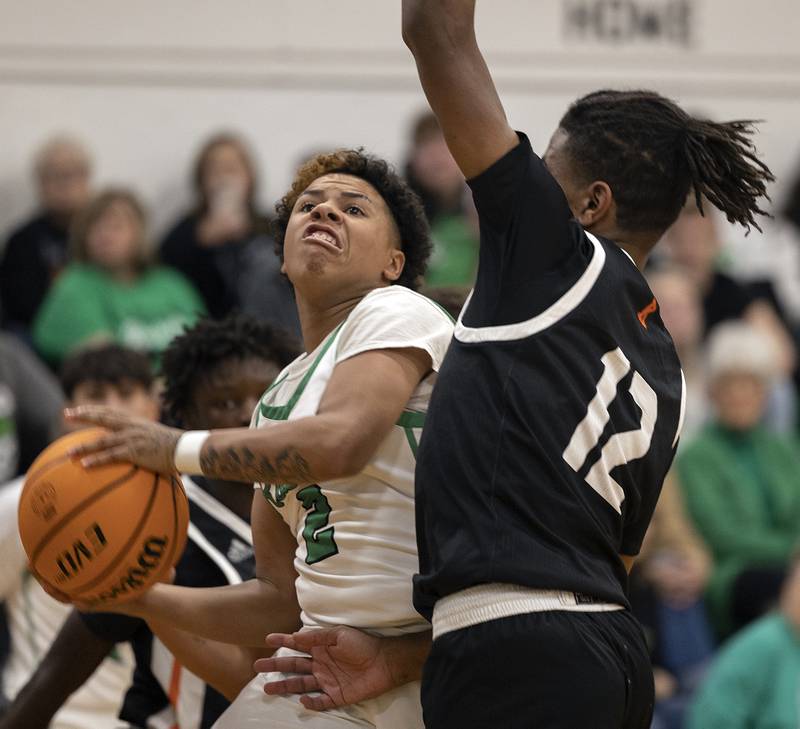 Rock Falls’ Kam Hicks eyes the basket against Kewanee’s Brayden Conley Wednesday, Nov. 27, 2024, at Rock Falls High School.