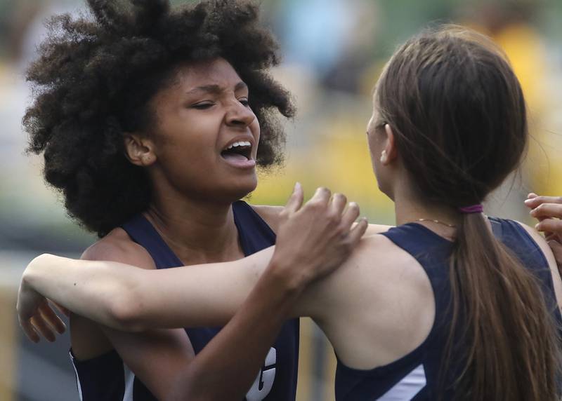 Cary-Groves Olivia Parker hugs her teammate Kate Aniolkowski hug each other after finishing the 300 meter hurdles on Thursday, May 2, 2024, during the Fox Valley Conference Girls Track and Field Meet at Jacobs High School in Algonquin.