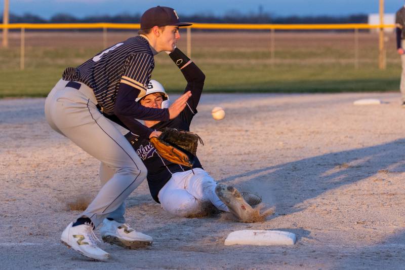 Payton Twait of Serena slides into third base as Thomas Giebel of Hiawatha fields ball on Monday, April 7, 2025 at Serena High School in Serena.