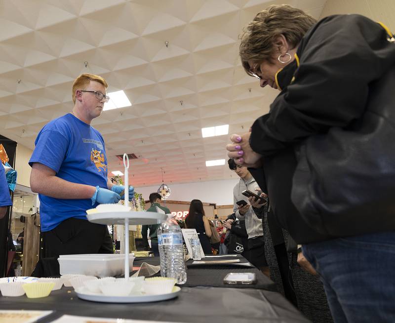 Sterling High School WACC CEO student Josh Greenfield speaks with a customer Wednesday, April 26, 2023 during the CEO trade show at the Northland Mall. The trade show is the proverbial final for the young entrepreneurs. Students will be back selling their goods and services on Thursday.