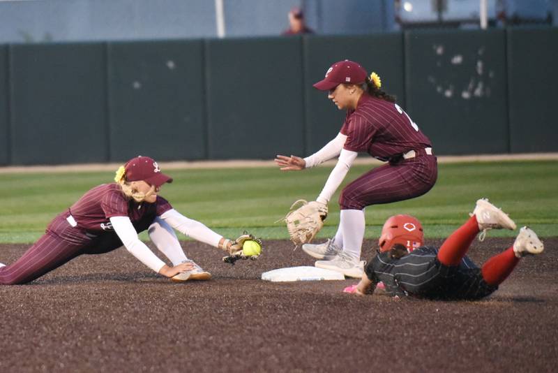 Lockport's Mikayla Cvitanovich, left, lunges towards second base to try and tag out Bradley-Bourbonnais' Tristin Woods, right, as the Porters' Marie Baranowski looks on during the Class 4A Illinois Wesleyan Supersectional Monday, June 9, 2025.