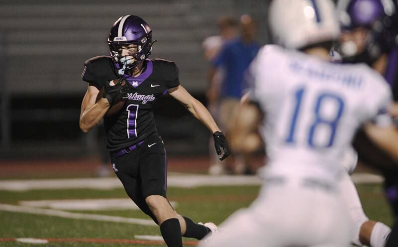 Rolling Meadows’ Ben Petermann cuts into the hole for a touchdown against Vernon Hills in a football game in Rolling Meadows on Friday, September 9, 2022.