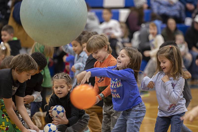 Adilyn Wingert, 6, tosses a large ball at Grinch and company Saturday, Nov. 19, 2022 during Rock Falls Chamber’s Grinch dodgeball.