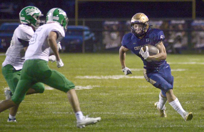 Marquette’s Payton Gutierrez looks to get by the Ridgewood defense on a run in a game last season at Gould Stadium in Ottawa.