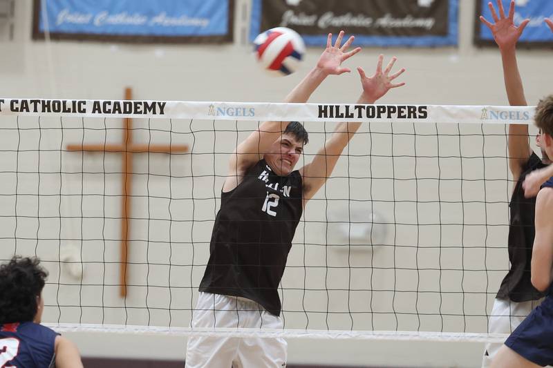 Joliet Catholic’s Austin Bernhard blocks a shot for a point against St. Viator on Wednesday, April 24, 2024 in Joliet.