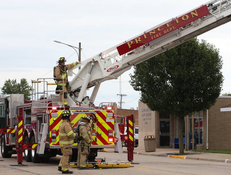 Princeton firefighters use their aerial truck to fight a fire at 201 North Main Street on Monday, Aug. 14, 2023 in Ladd.