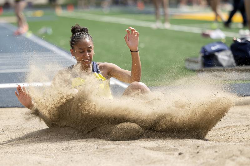 Sterling’s Alivia Gibson splashes down in the long jump pit Wednesday, May 14, 2025, during Sectionals at Sterling High School.