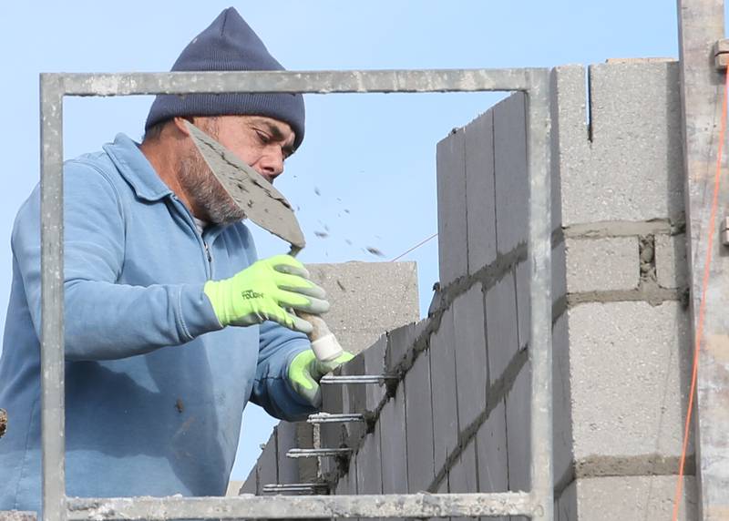 A worker with Vissering Construction lays masonry on a addition to the west side of Northwest School on Tuesday, Nov. 7, 2023 in La Salle.