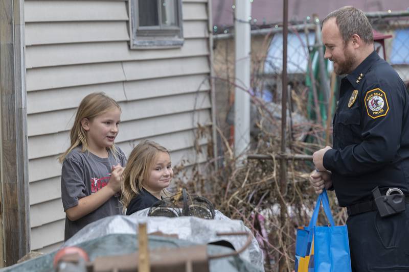 Payton, 9, and Kinsley thank Rock Falls Police Chief Ryan McKanna Monday, Dec. 22, 2025, as he brings in gifts and food items to their home.