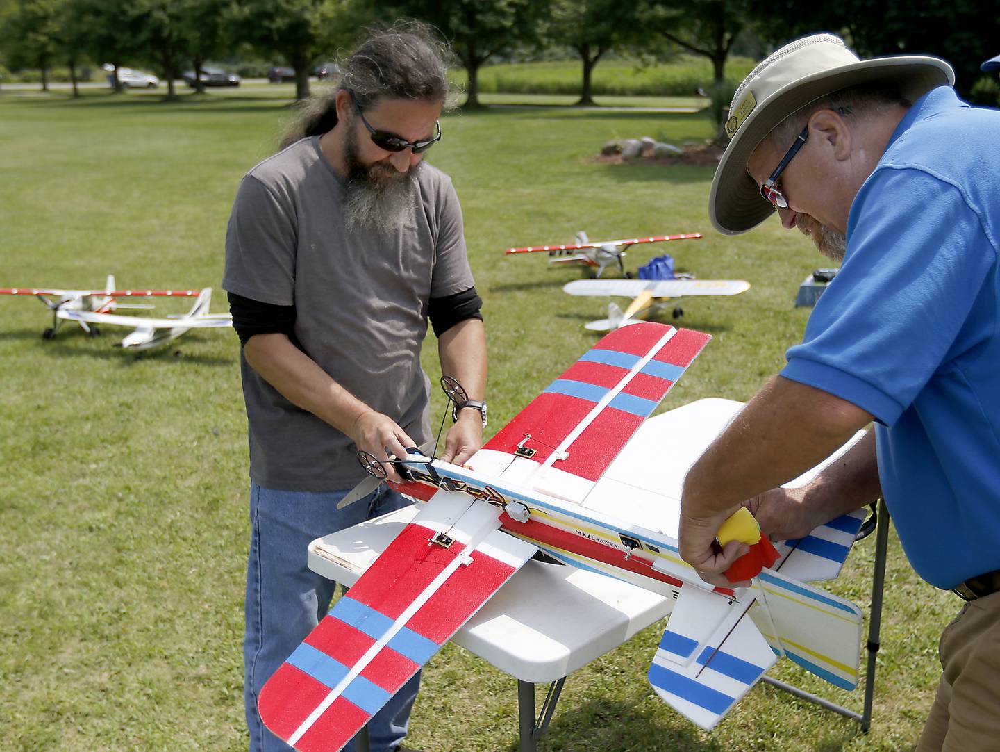 Joe McGinley and Larry Erbach prepare McGinley’s radio-controlled plane on Thursday, Aug. 8, 2024, while flying planes with other members of the Chain-O-Lakes Eagles R/C Club near Hebron.