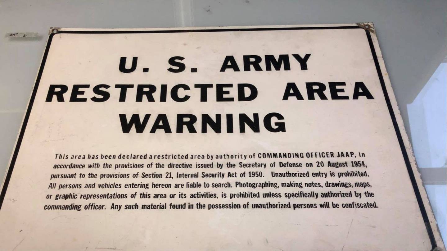 This "U.S. Army Restricted Area” sign was a standard metal sign that was used by the hundreds on fences and buildings throughout the plant. This one cites an October 1954 Defense Directive. These were in use through at least the year 1996 so it could date anywhere between 1954 and 1996.