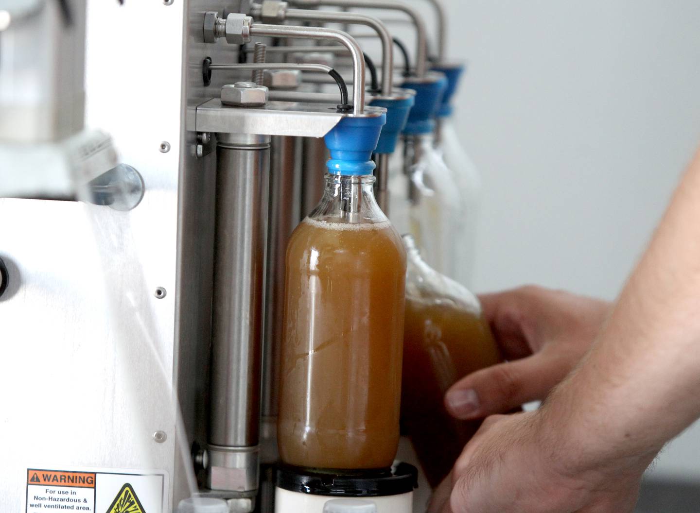 Co-founder Josh Carnell bottles horchata root beer at Sunset Soda in Geneva. Sunset Soda began production of small batch artisanal craft soda last March.