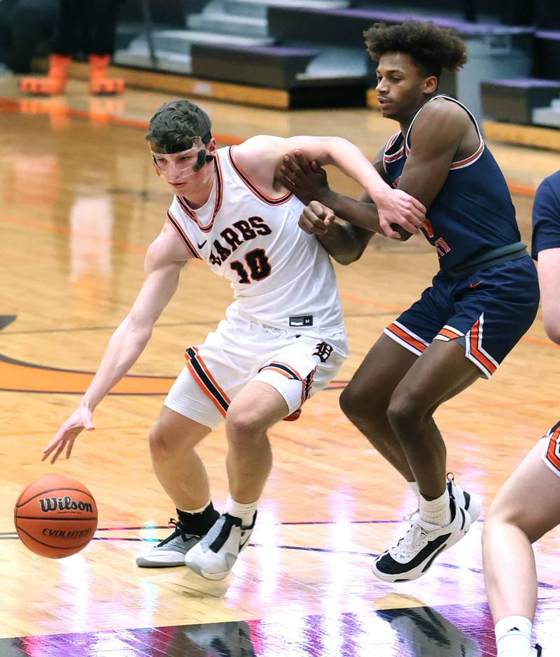 DeKalb's Eric Rosenow drives around Naperville North's Luke Williams during their game Monday, Jan. 30, 2023, at DeKalb High School.