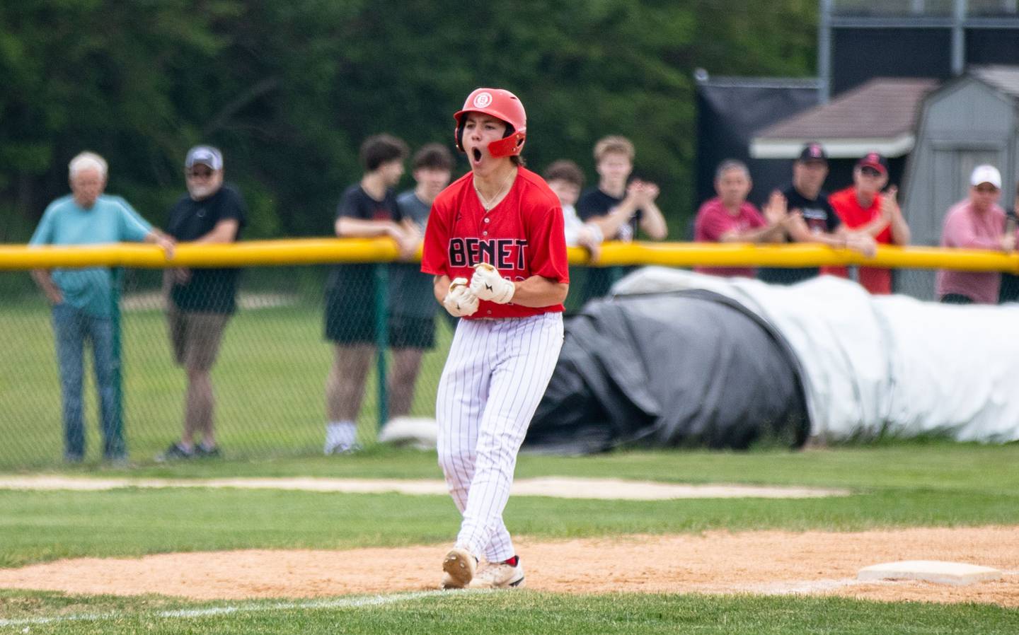 Benet Academy’s Merrick Sullivan celebrates his RBI triple during the Class 3A Kaneland Sectional final at Kaneland High School in Maple Park on Saturday, June 7, 2025.