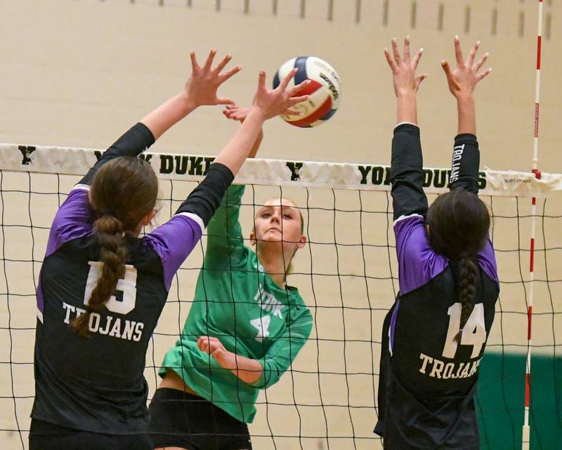 York's katie Day (4) gets the ball past Downers Grove North defenders Nora Benjamins, left, and teammate Ellery Cabaj (14) during the game on Tuesday Oct. 22, 2024, held at York High School in Elmhurst.