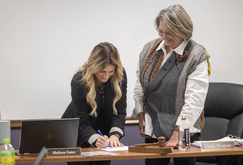 Melydi Huyett signs on Wednesday, Dec. 17, 2025, to become the next superintendent of Dixon Public Schools. The selection was approved at Wednesday’s board meeting.