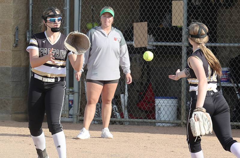 Sycamore's Alyssa Wilkerson flips the ball to Kaitlyn Williams to record an out during their game against LaSalle-Peru Tuesday, April 11, 2023, at Sycamore High School.