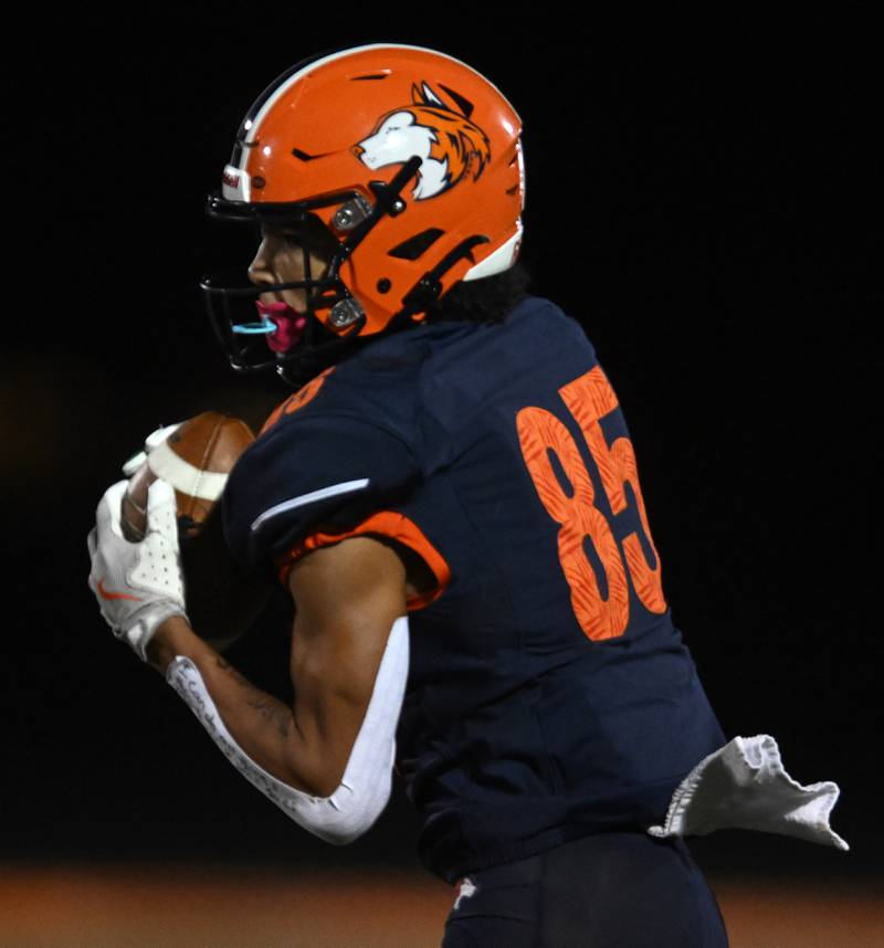 Naperville North’s Quinn Morris catches a pass during a football game against Neuqua Valley Friday.