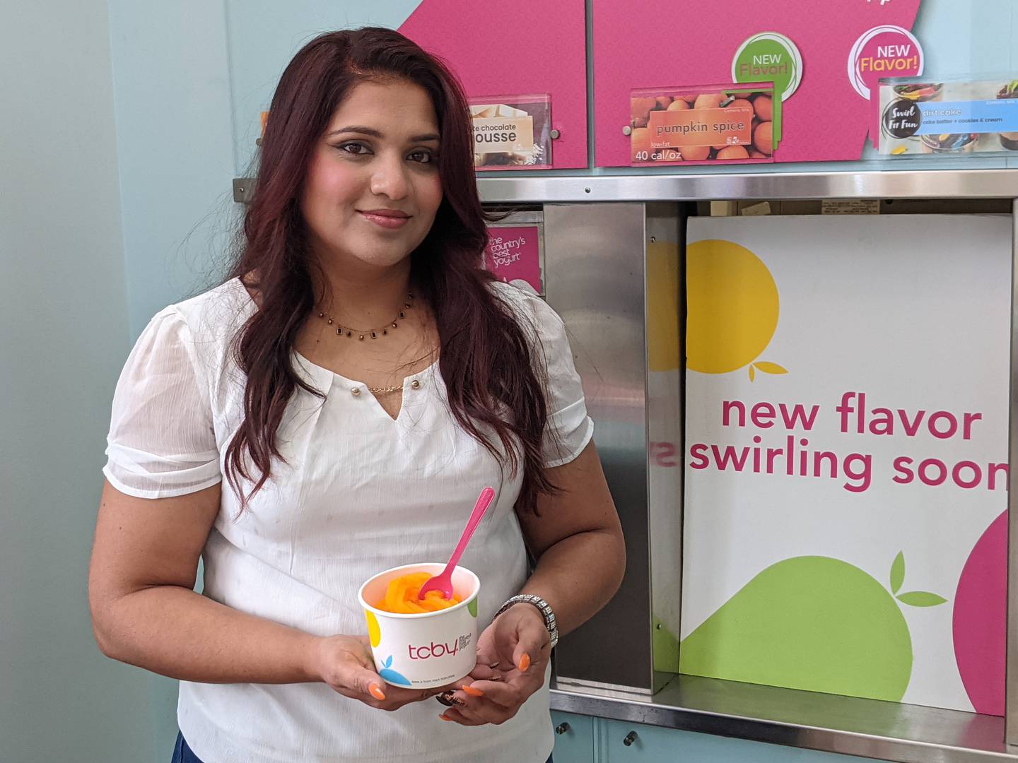 Ankita Patel shows one of the options available at TCBY, at 2840 U.S. Route 34 in Oswego.